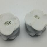 pair of white APILCO porcelain candlesticks in the shape of pink flowers