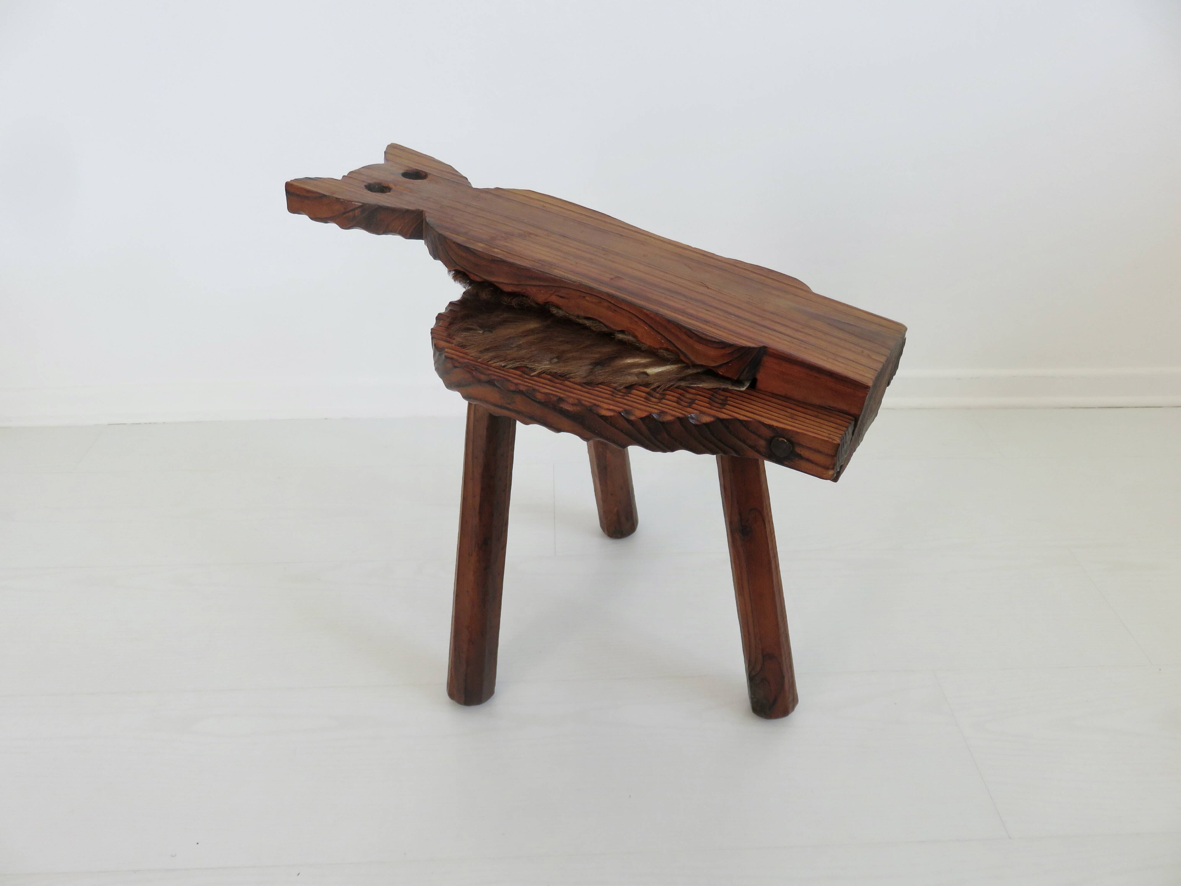 Brutalist cowhide tripod stool in solid wood