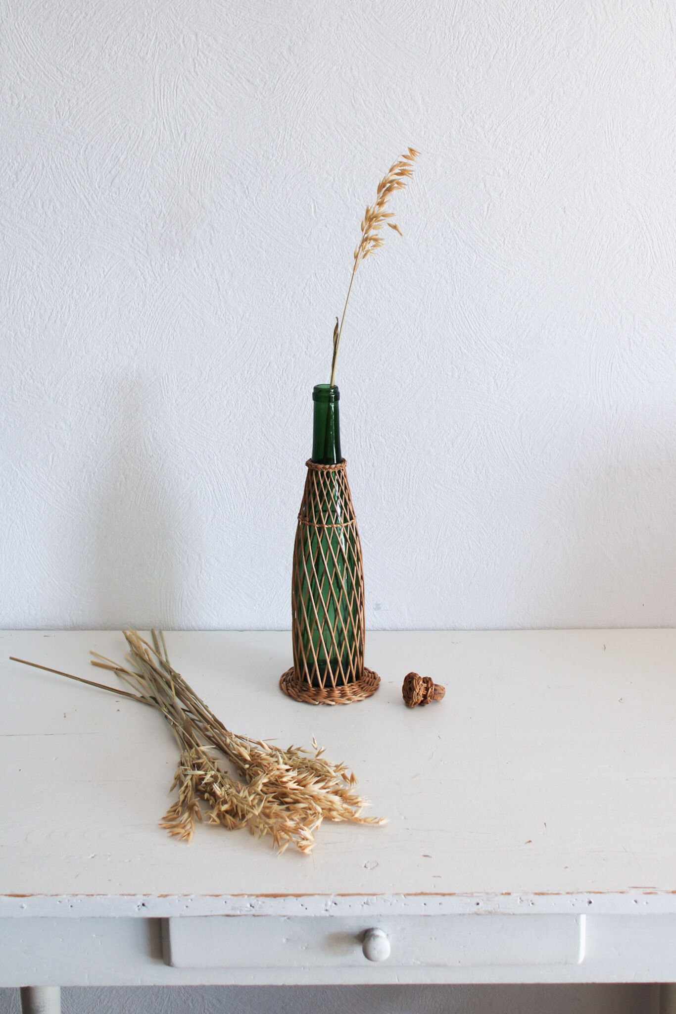 Glass and wicker bottle