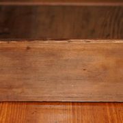 Vintage wooden furniture for 45 wine bottles with a drawer.
