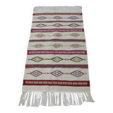 Tribal bohemian kilim rug with geometric pattern in wool.