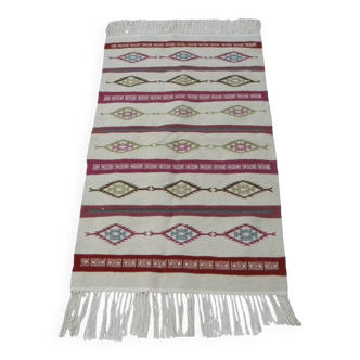 Tribal bohemian kilim rug with geometric pattern in wool.