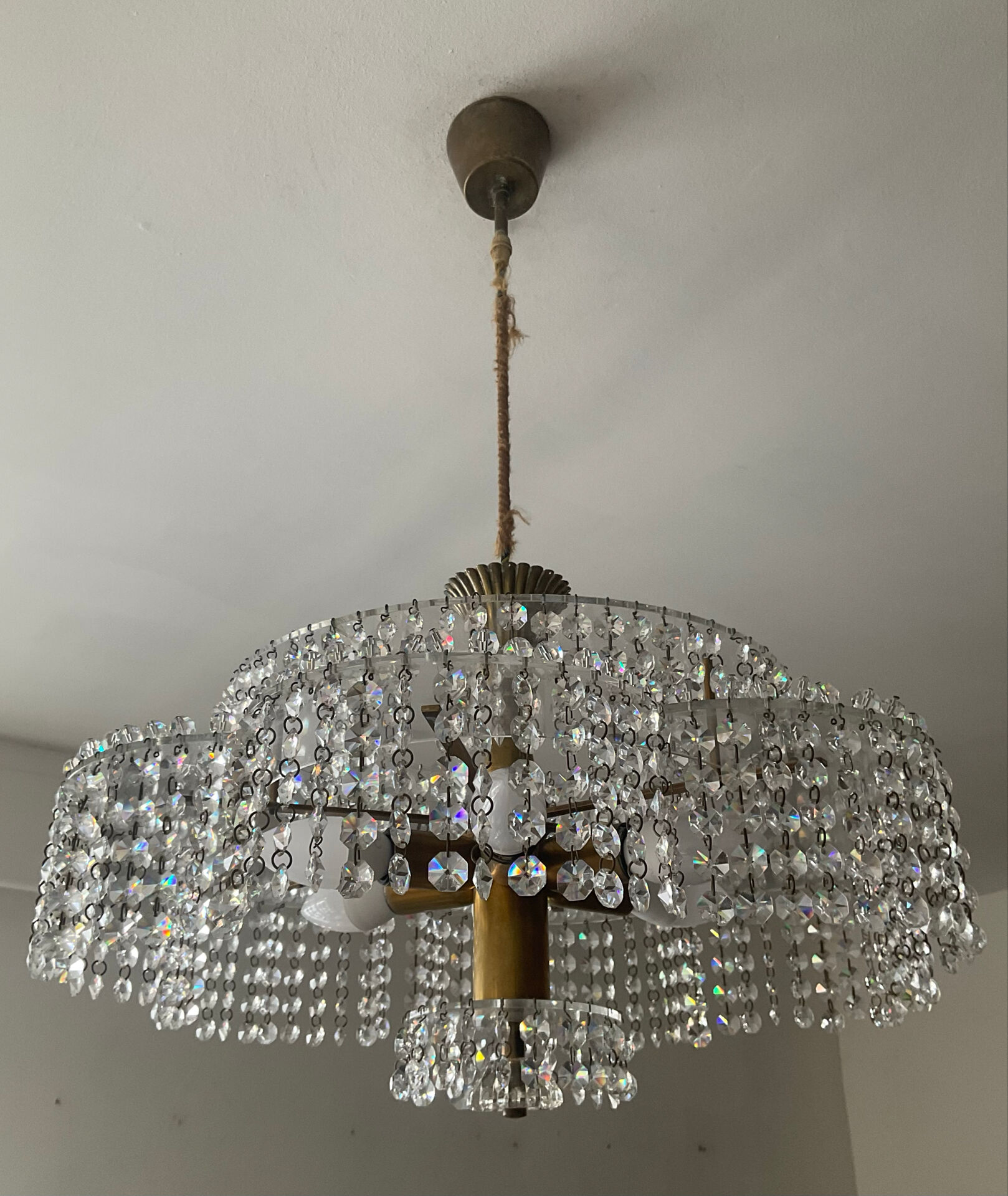 Vintage lucite chandelier with a cascade of crystal pendants from the 1970s.