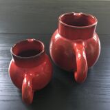 Pair of red pitchers