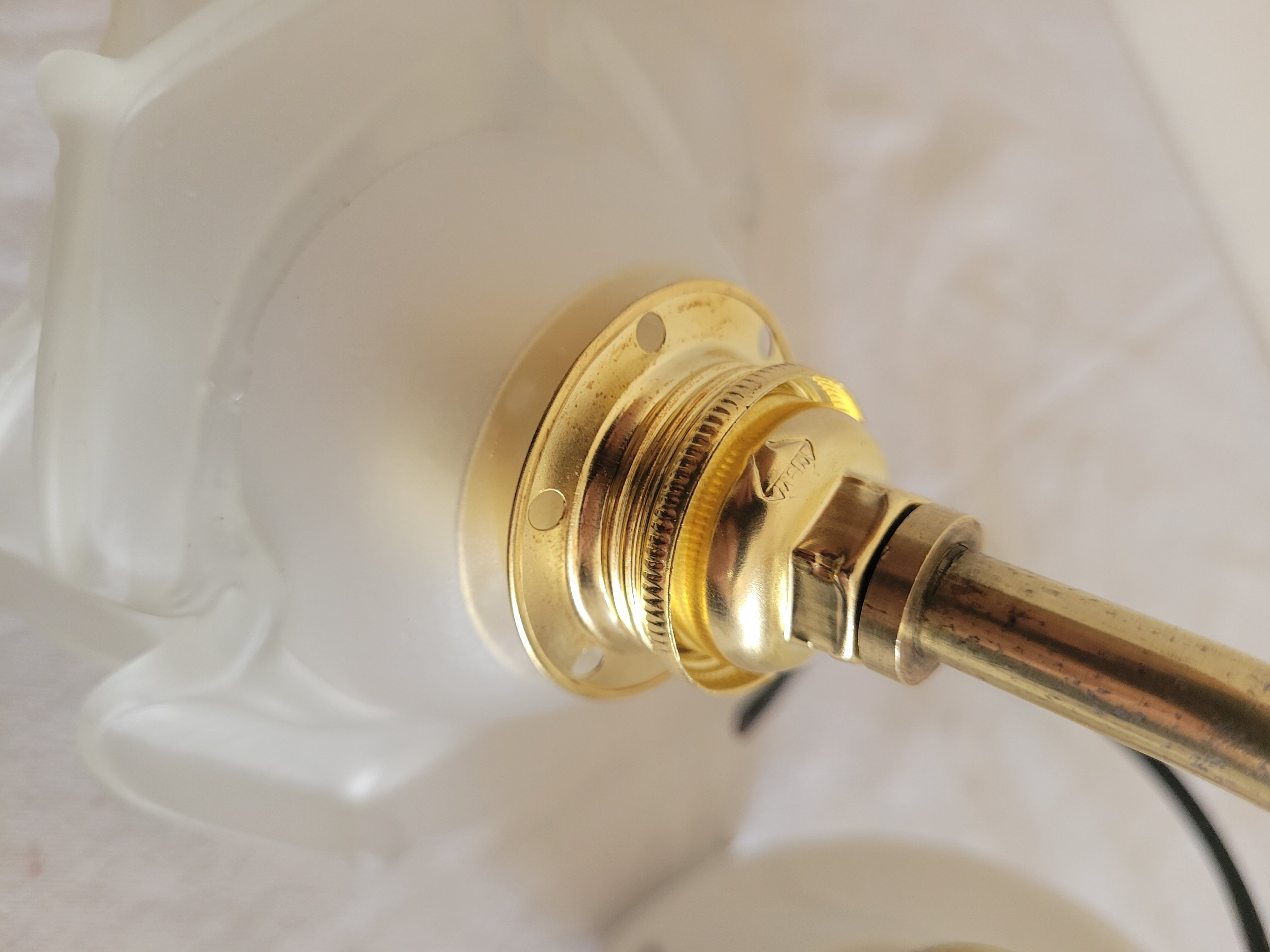 Brass flower and frosted glass sconce