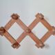 Wall-mounted accordion coat rack in solid pine
