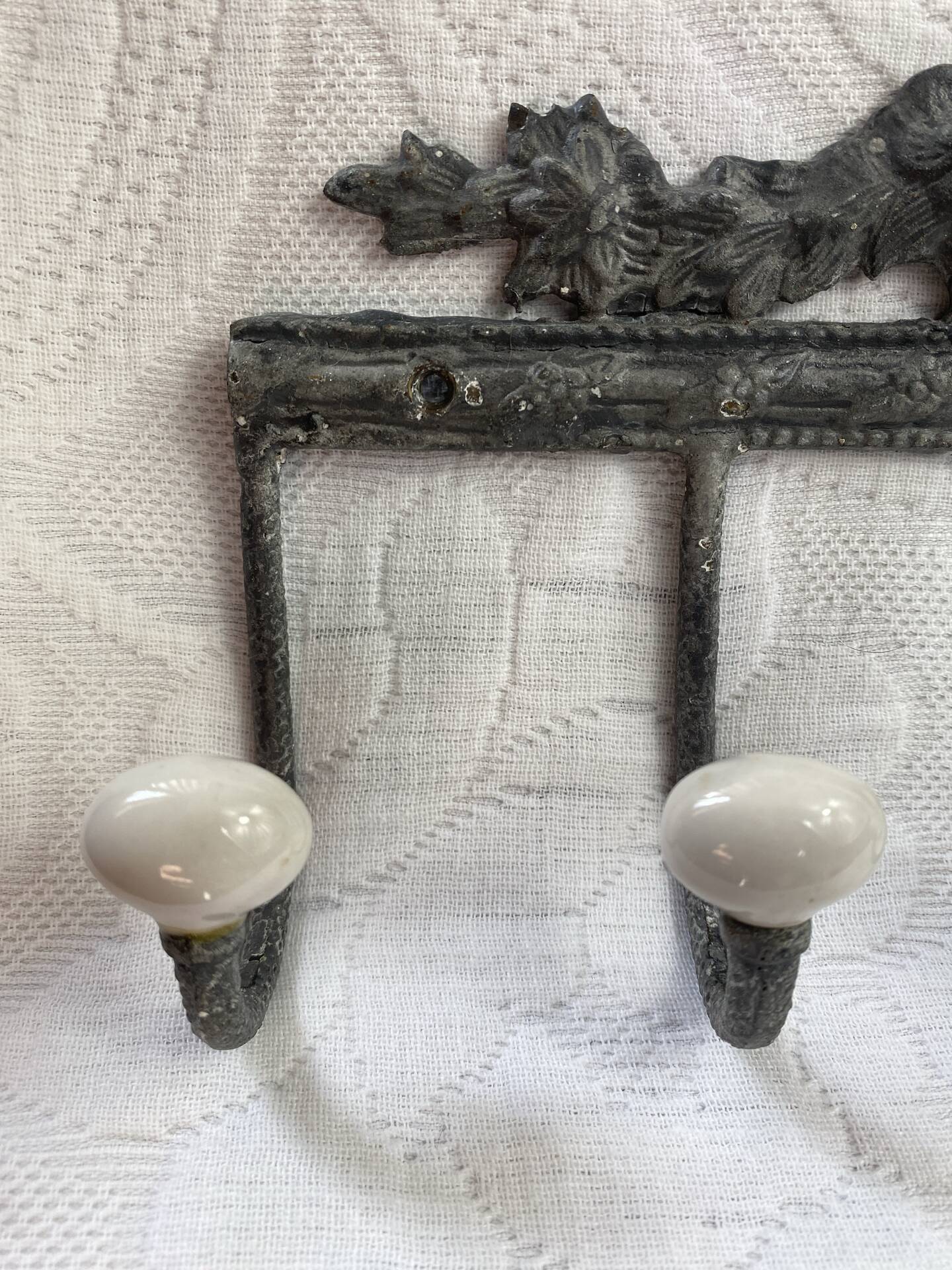 Patinated metal wall bracket and porcelain