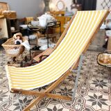 Vintage folding deckchair with yellow striped canvas