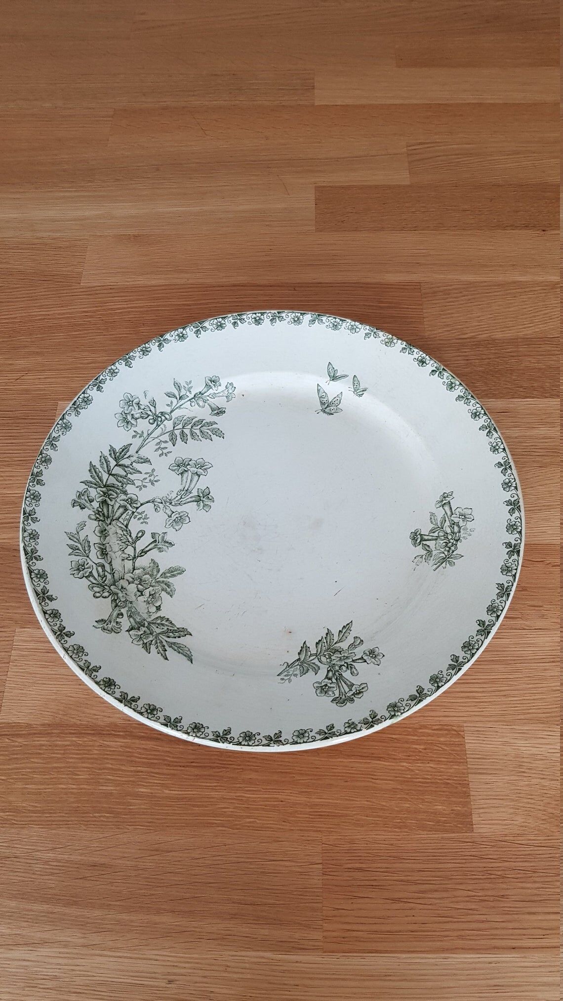 White and green ceramic dish decorated with flowers and butterflies