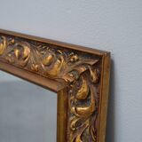 wall mirror in a decorative wooden frame.