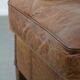 Cognac-coloured wingback armchair in English style made of cowhide leather
