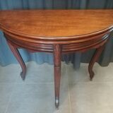 Half-moon mahogany game table on casters