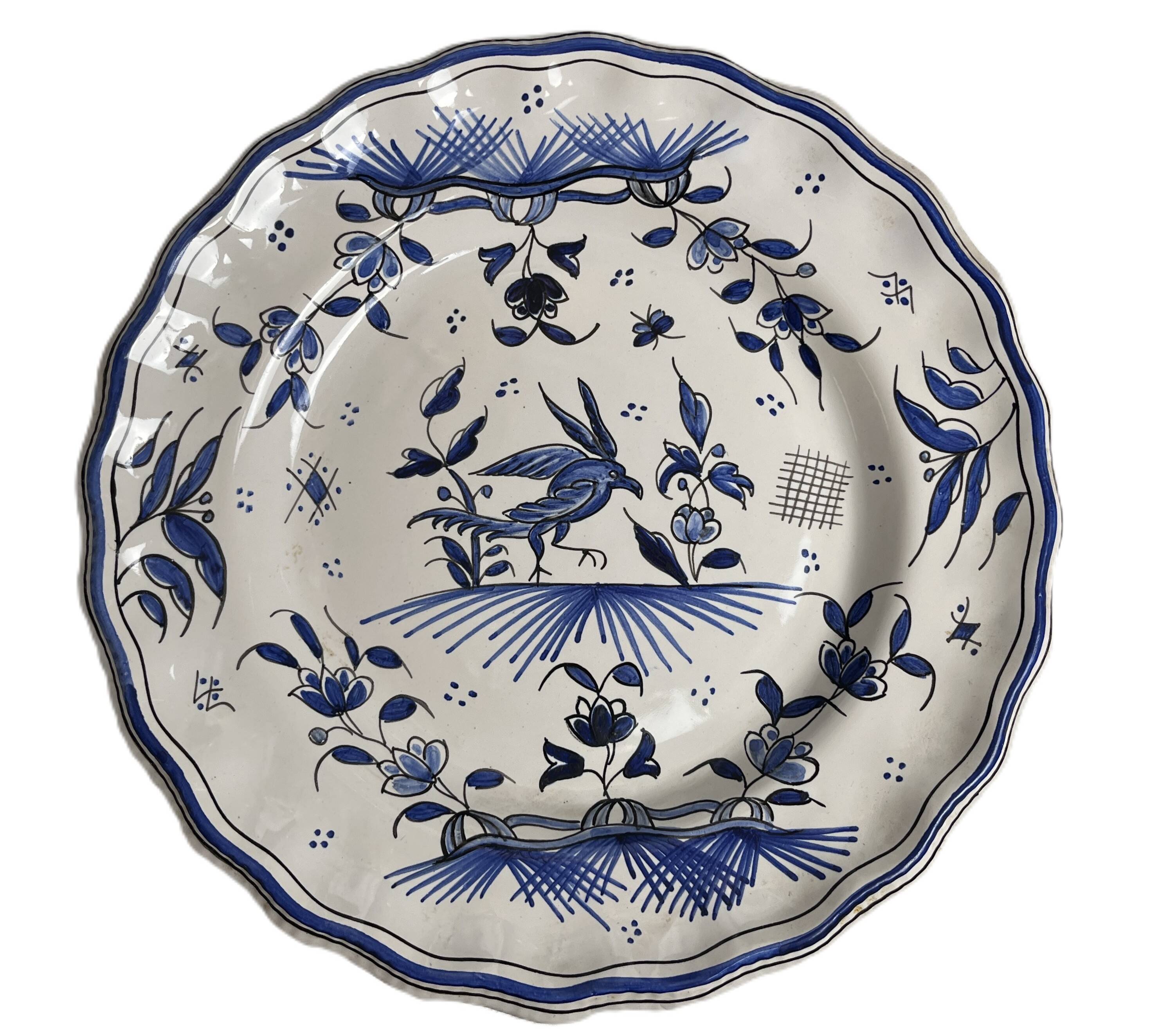 Moustiers, pairs of plates with wading bird design, scalloped edge, early 20th century.