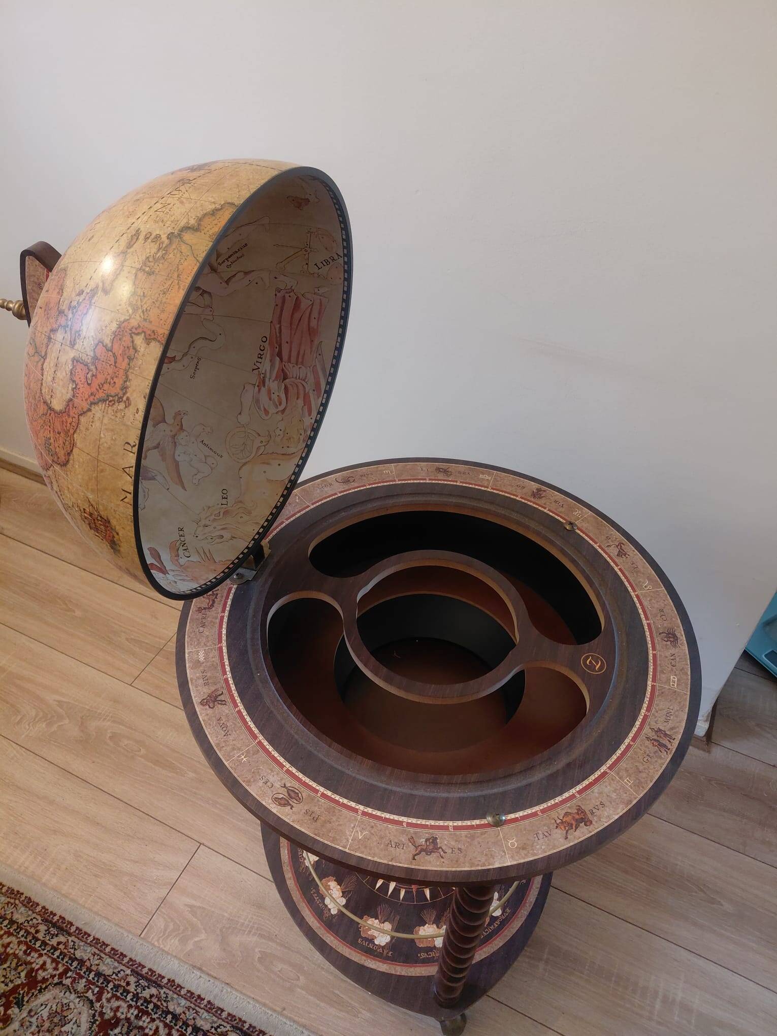 Vintage globe bar with storage for bottles and glasses.