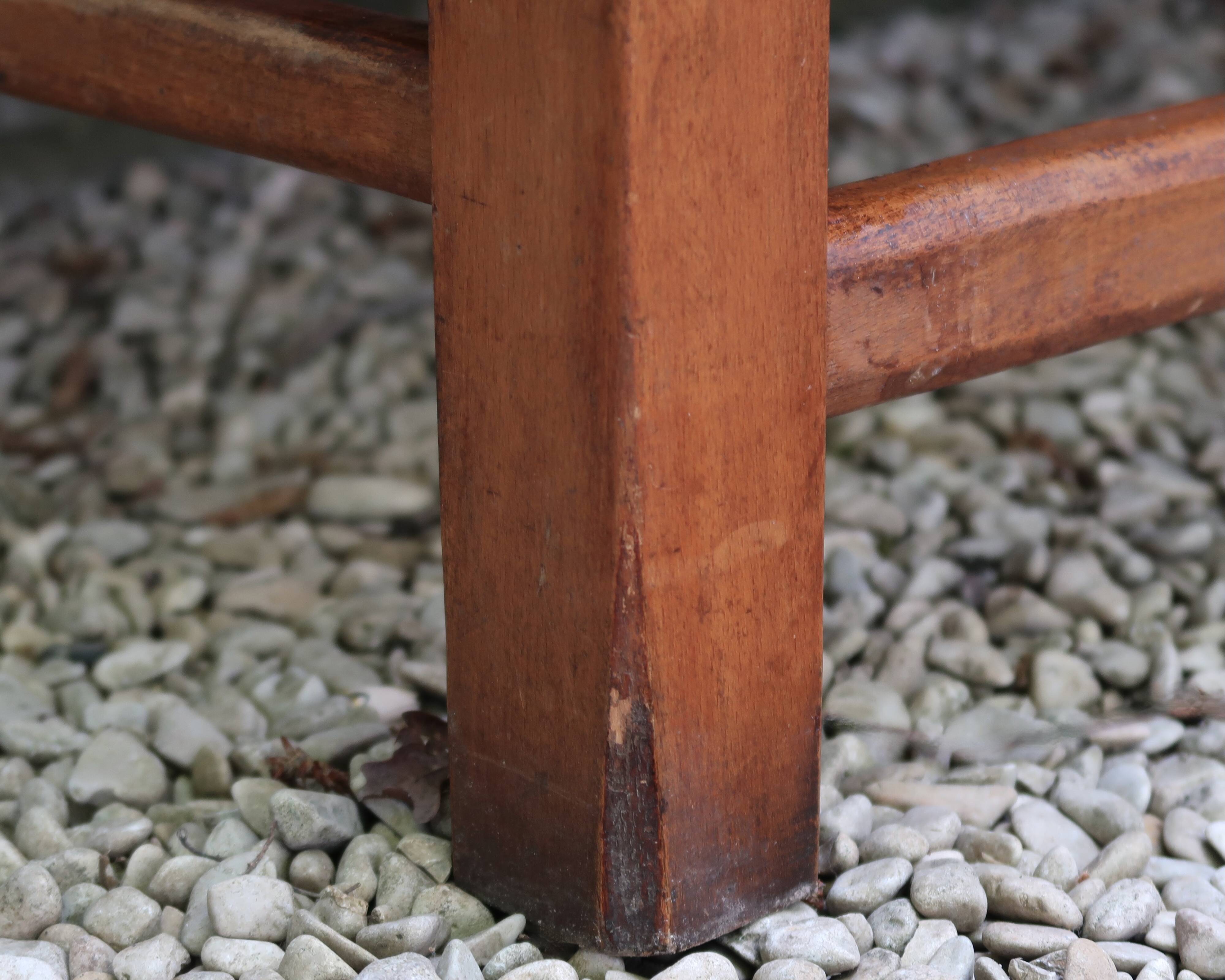 Wooden-backed bench with straw seat, 1970s.