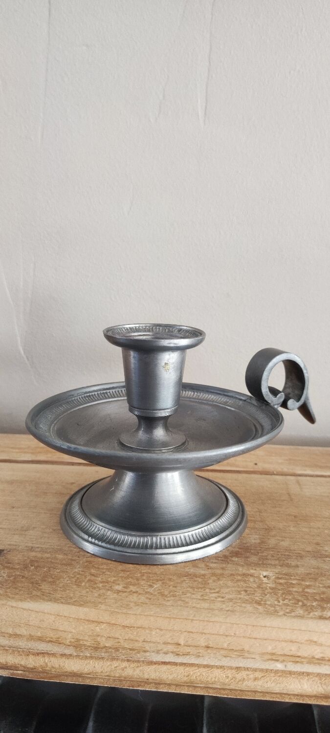 Tin hand candle holder.