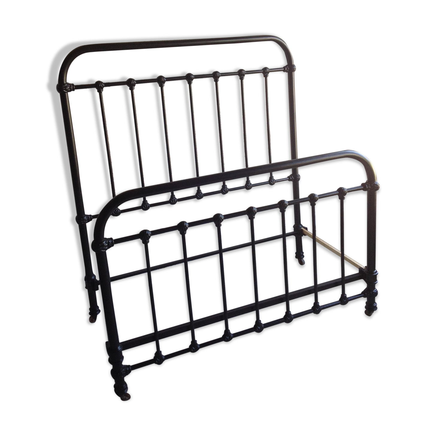 old bed with vintage painted metal bars