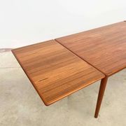 Teak dining table with integrated extensions — Scandinavian