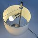 Large brushed metal table lamp with an ecru shade.