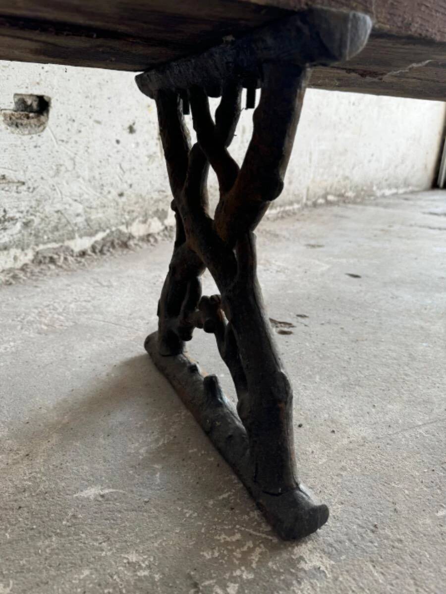 Dark brown wood and black cast-iron antique garden bench with weathered solid-wood seat