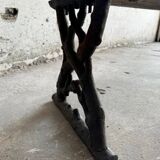 Dark brown wood and black cast-iron antique garden bench with weathered solid-wood seat