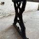 Dark brown wood and black cast-iron antique garden bench with weathered solid-wood seat