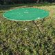Antique round folding garden table with a green patina.