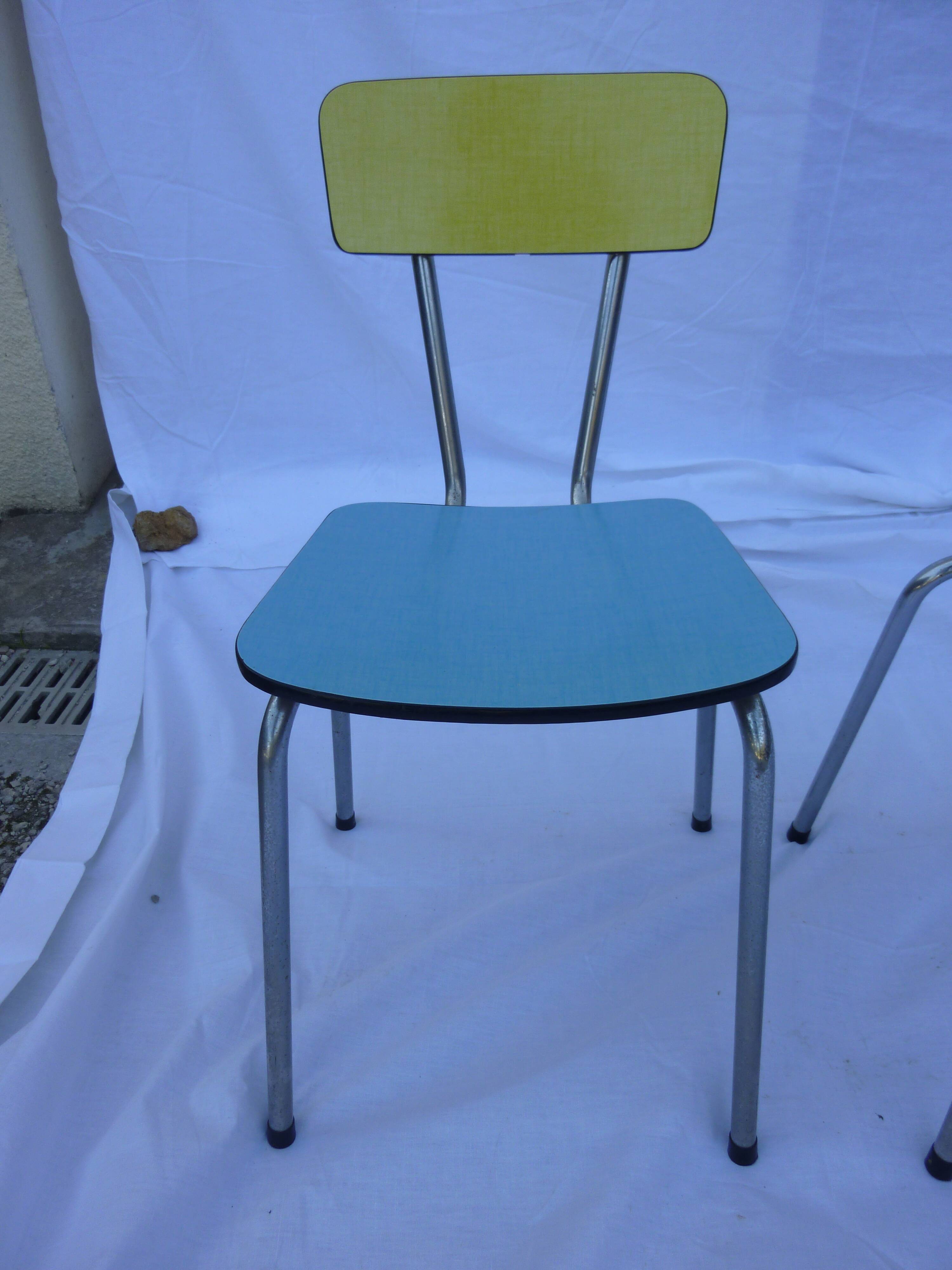 Two chairs and a yellow and blue stool in formica