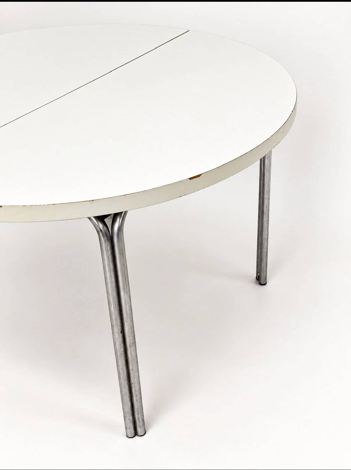 Vintage round extendable dining table, white laminate on chrome legs.