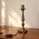 Vintage lamp base in patinated gold metal – foliage decor – 25 cm
