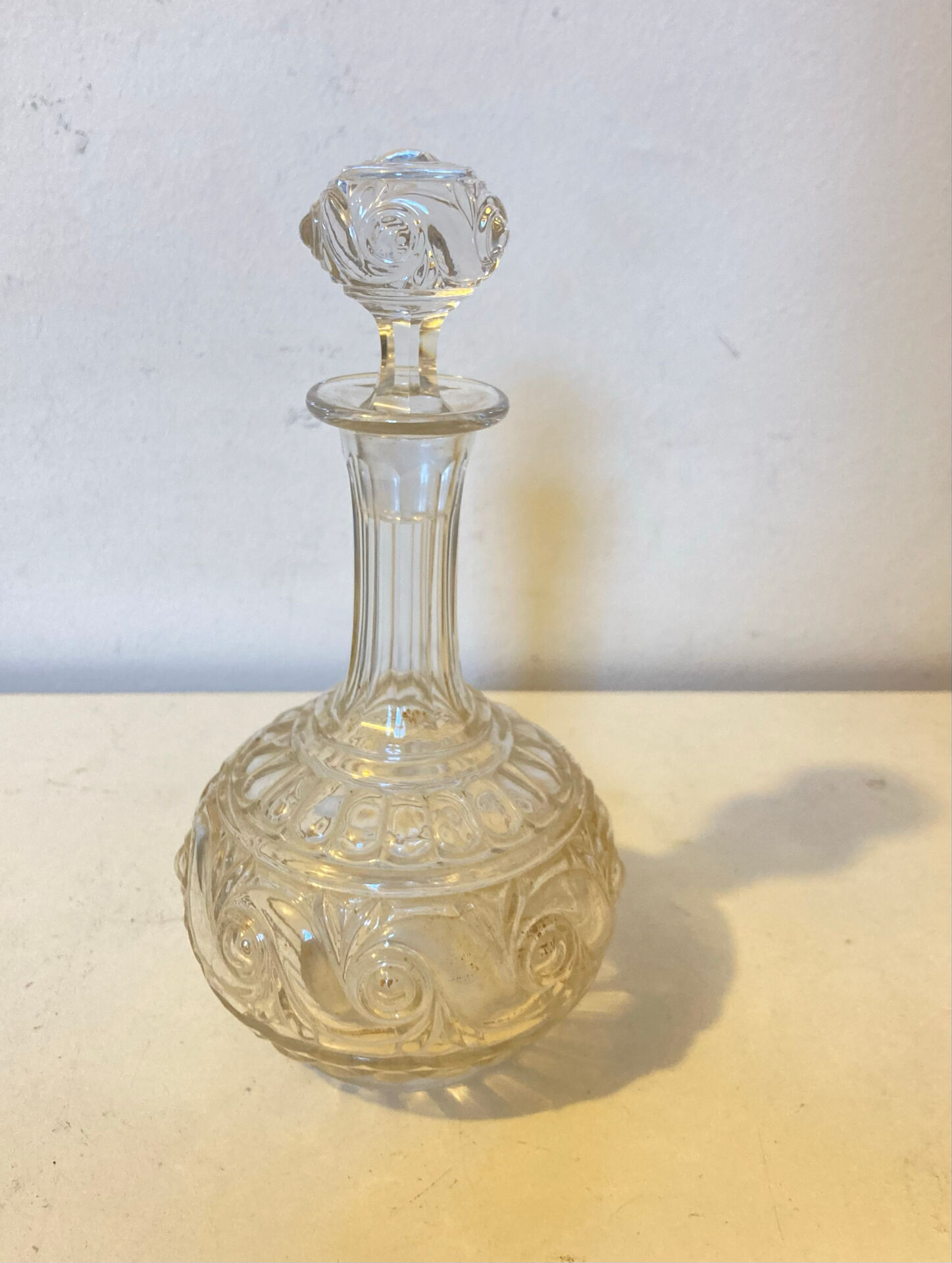 19th-century liqueur carafe in glass adorned with relief patterns.