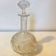 19th-century liqueur carafe in glass adorned with relief patterns.