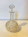 19th-century liqueur carafe in glass adorned with relief patterns.