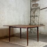 Extendable teak and teak veneer dining table