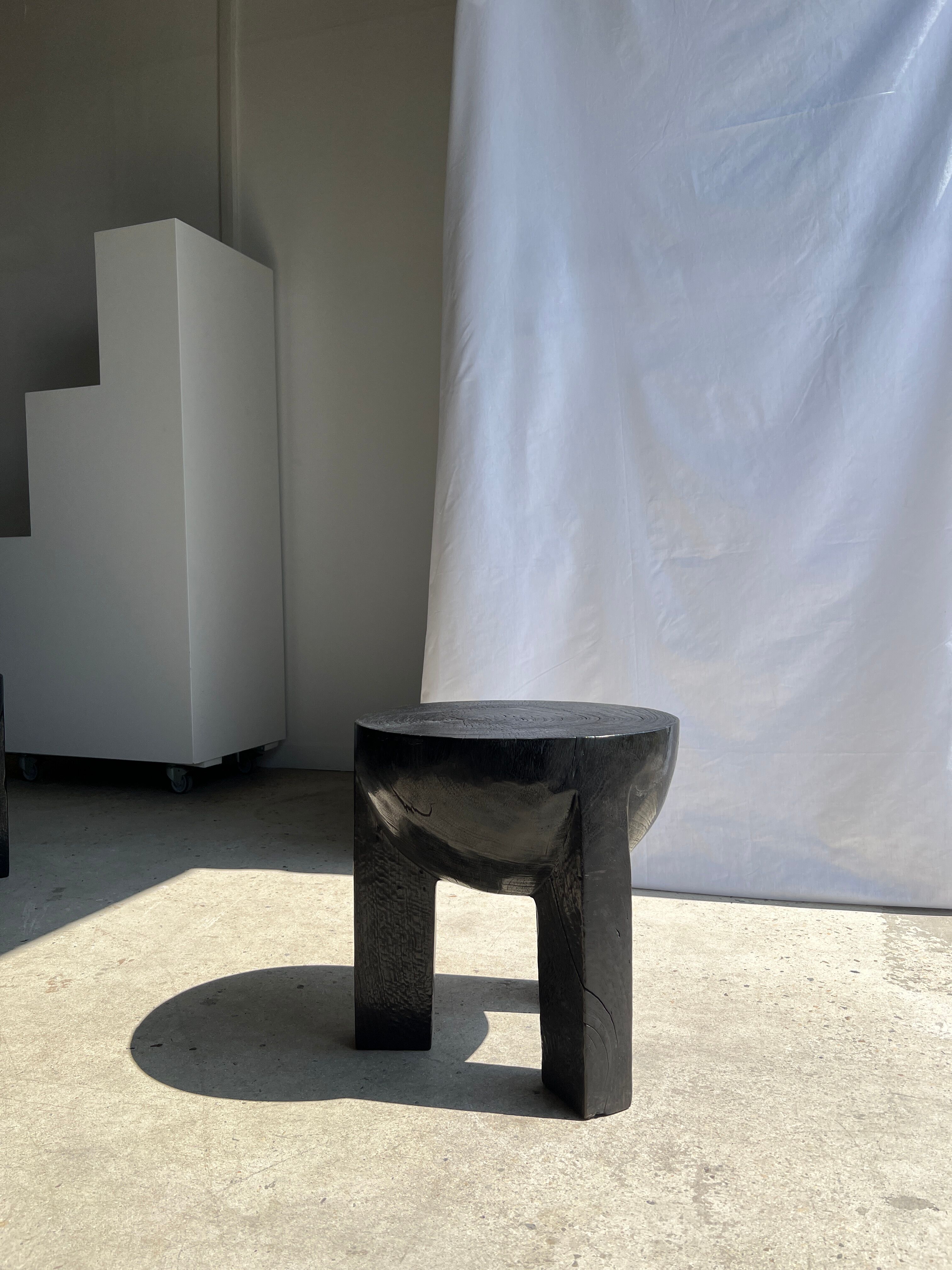 Black mango wood tripod side table with a semi-spherical top, height: 45 cm, diameter: 44 cm.