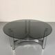 Round coffee table in smoked glass and chrome steel, 1970s design.