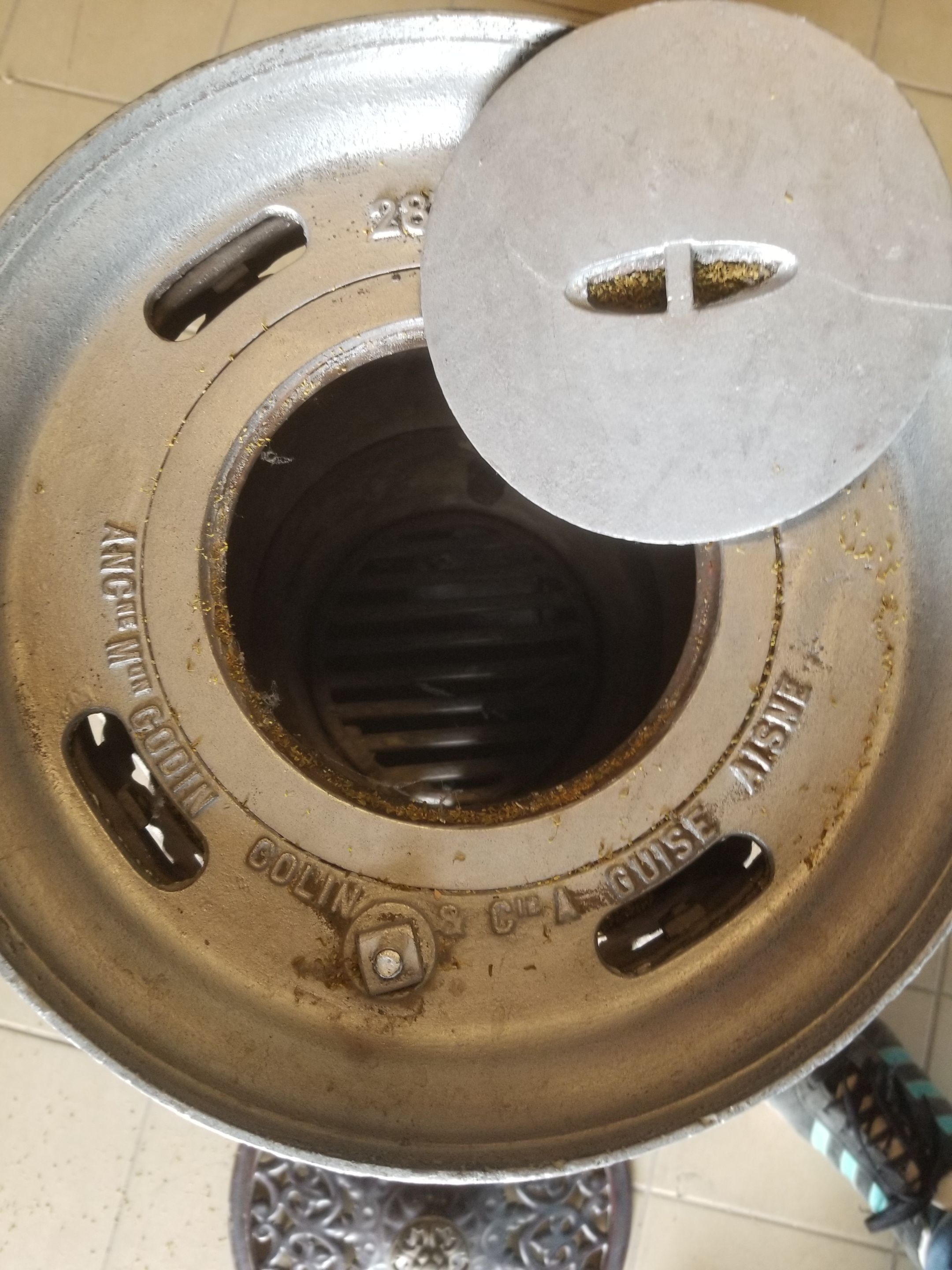 Old compact wood stove in enamelled cast iron with tripod feet with Lion's legs