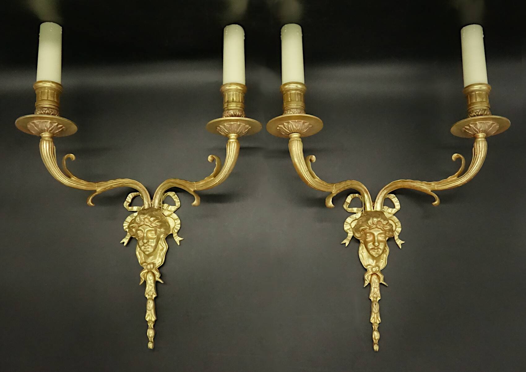 Pair of large Louis XVI style sconces with male faces - bronze