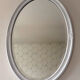 Vintage white oval mirror in resin.