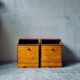 Pair of handcrafted solid wood bedside tables with drop-down doors.