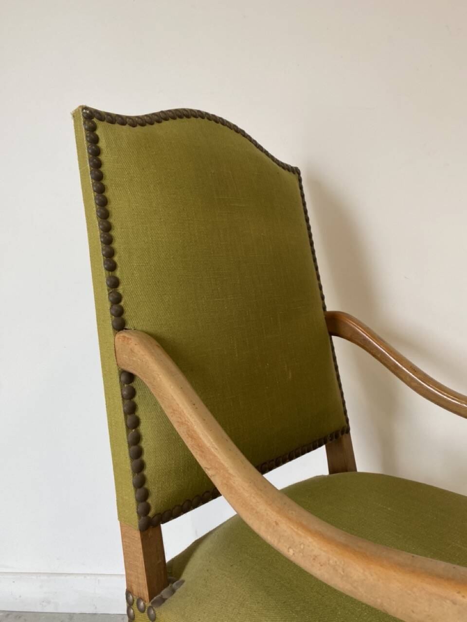 Olive green upholstered armchairs with studs