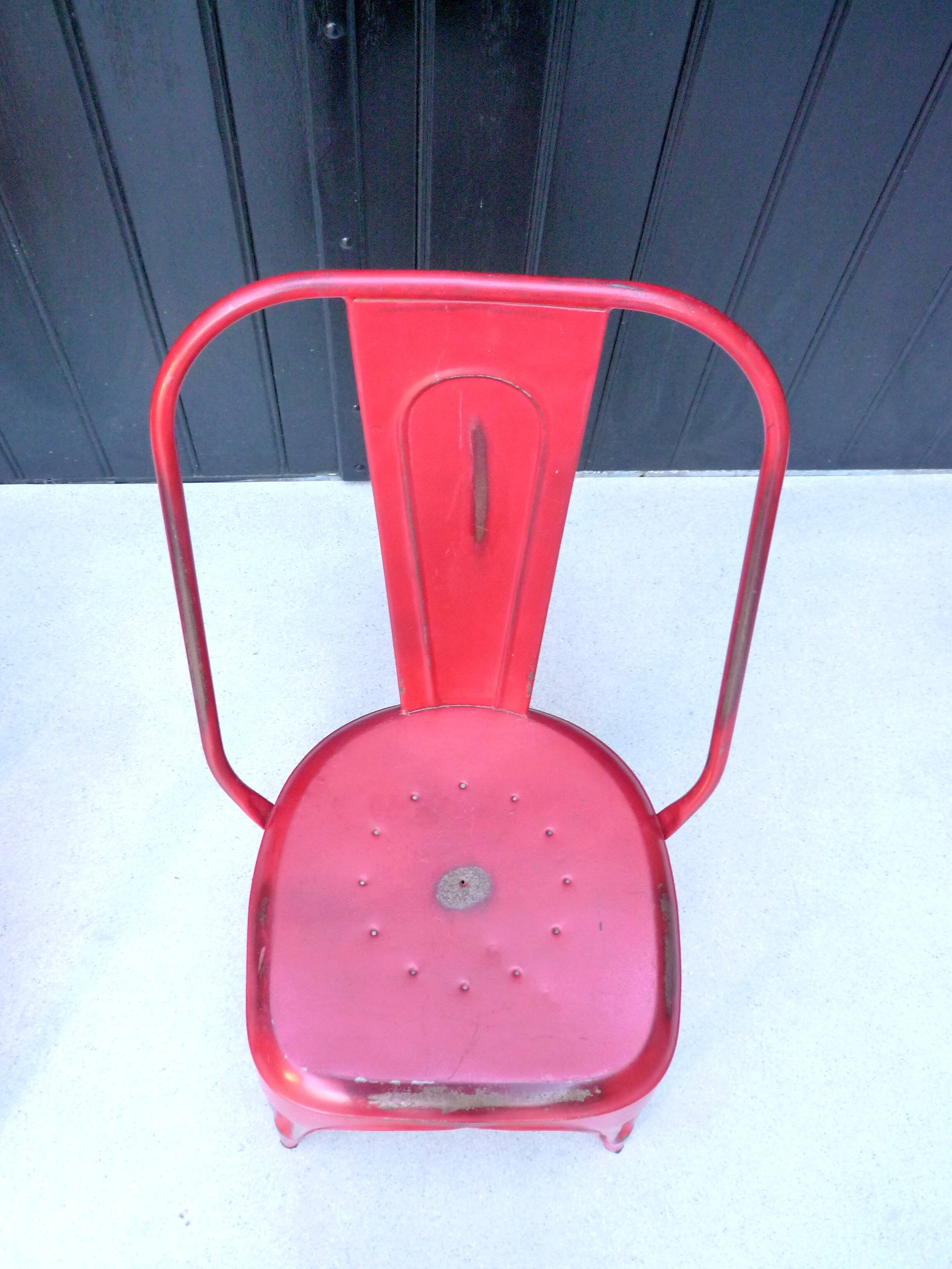 Pair of red stackable metal chairs