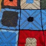 Hand-knitted patchwork blanket