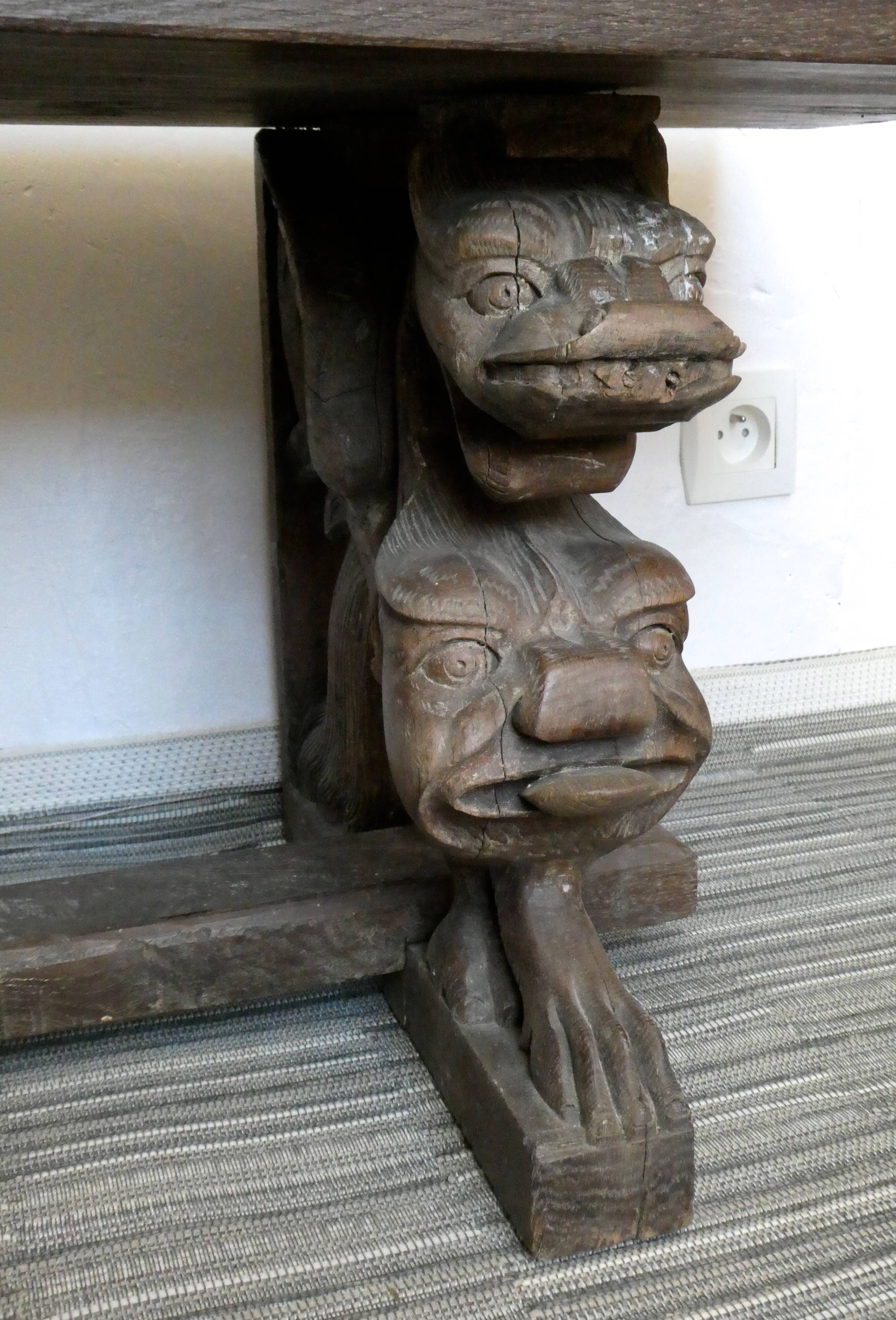 Gothic bench made of solid wood, heads of carved grotesques
