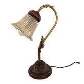 Gold swan neck table lamp with amber tulip glass.