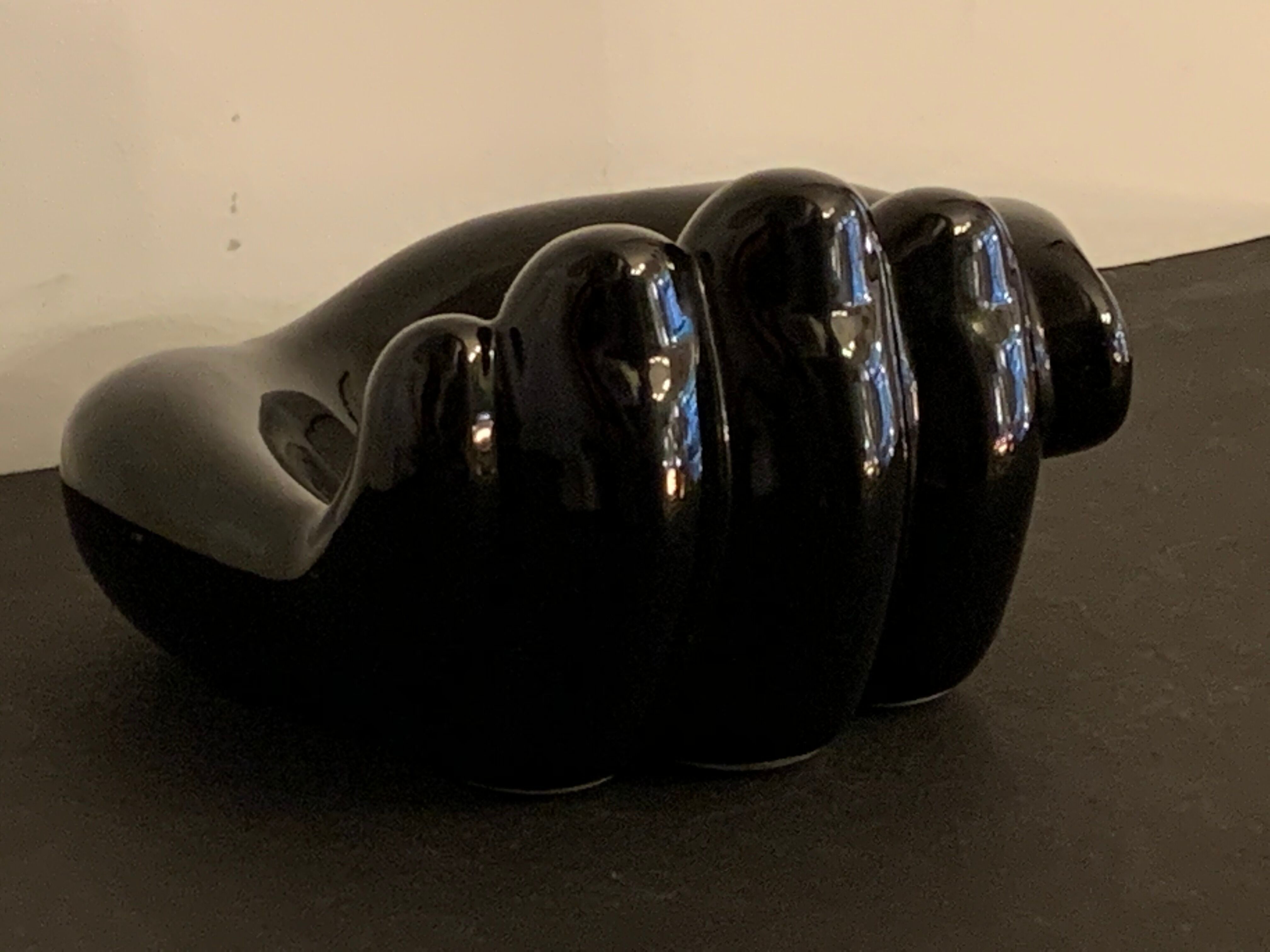 Black ceramic ashtray left hand