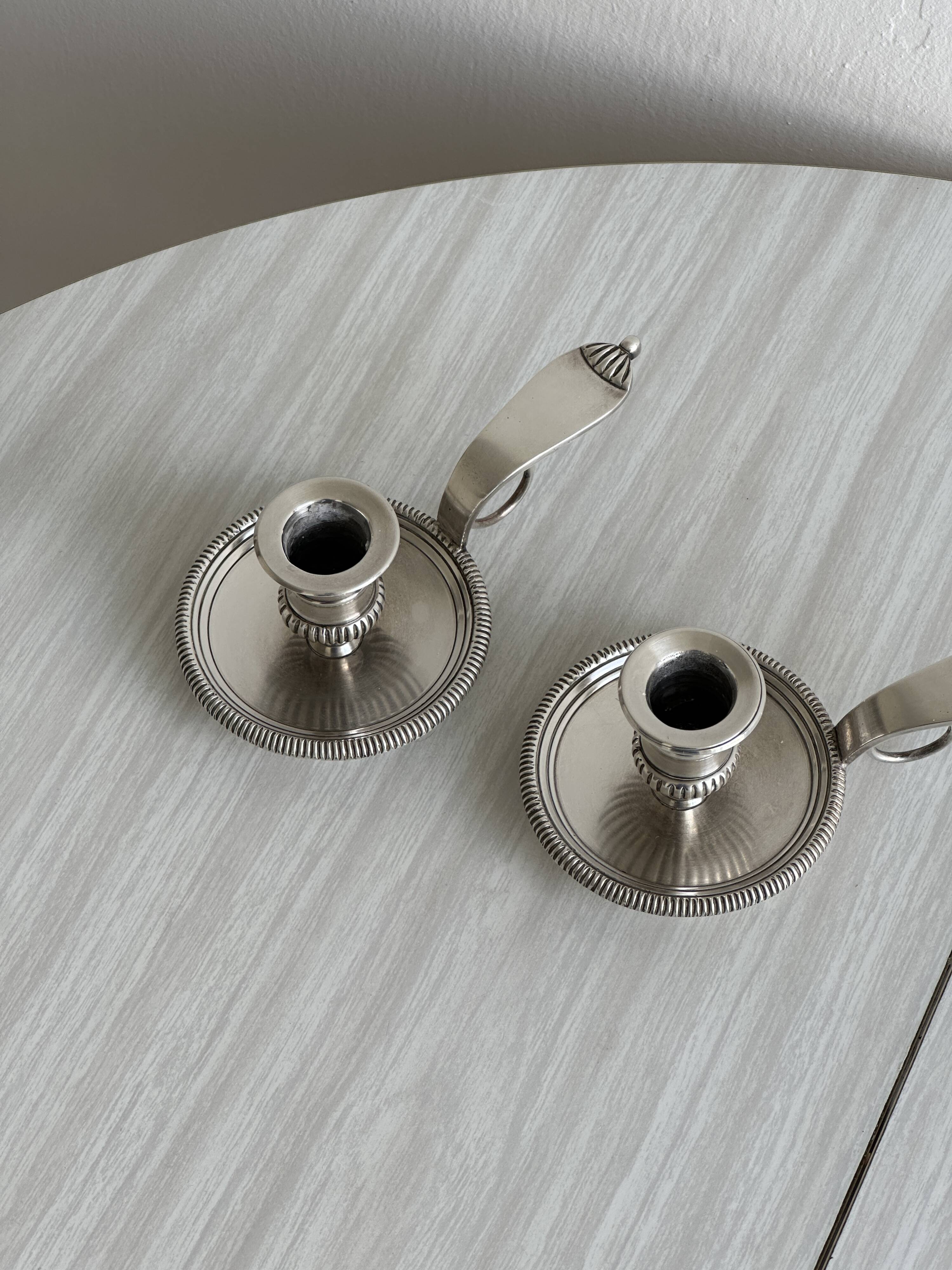 Pair of shiny silver metal candlesticks