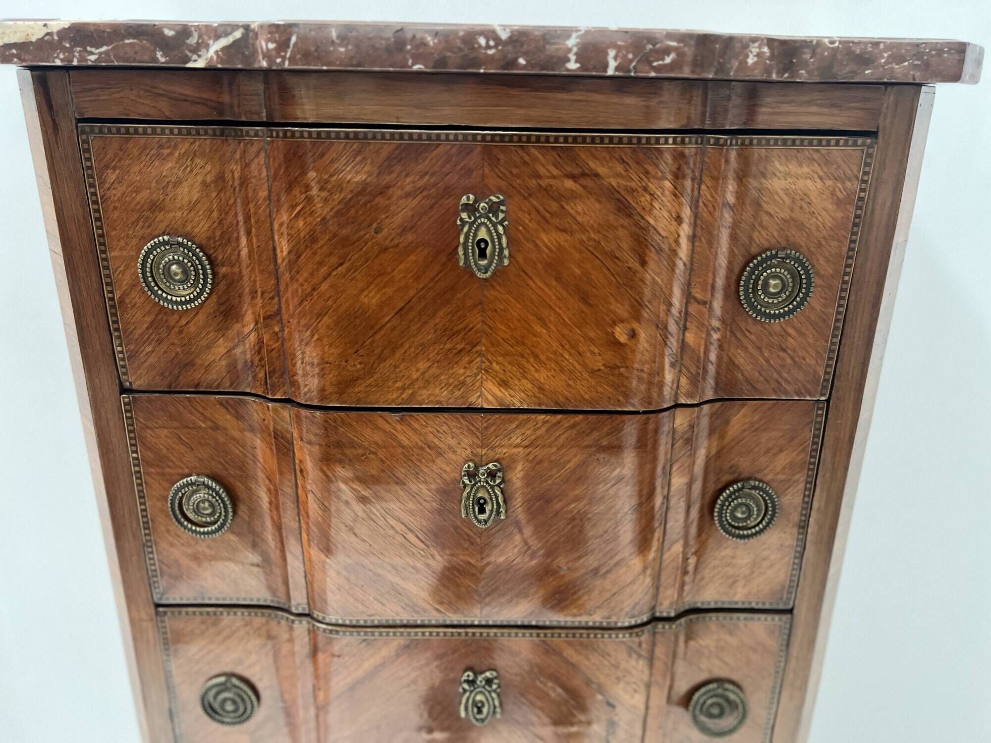 Transitional style chest of drawers in rosewood and amaranth veneer, 20th century.