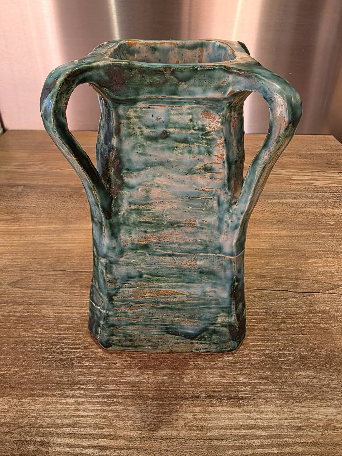 Vintage brutalist ceramic vase with 4 green handles.
