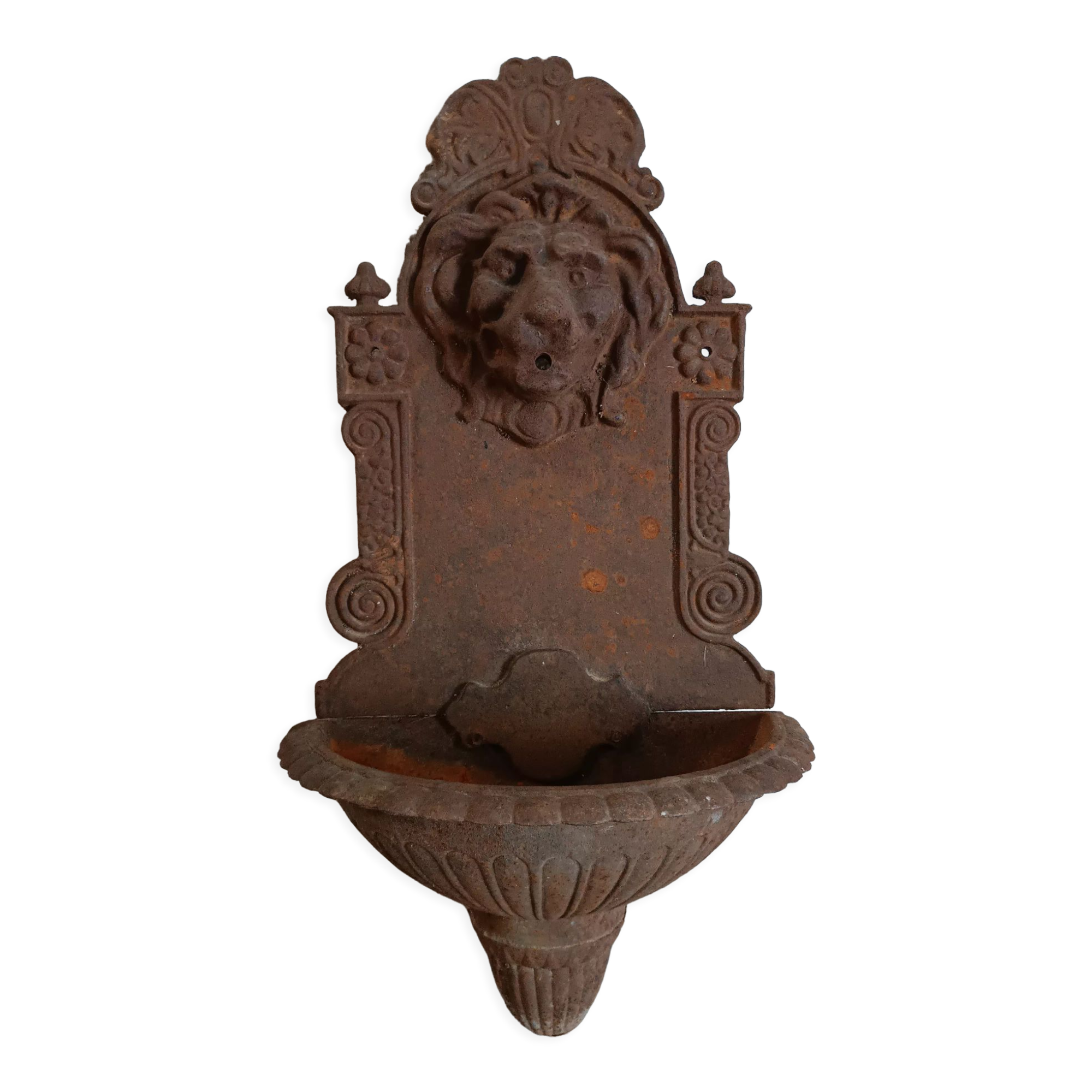 Old cast iron wall fountain with lion's head
